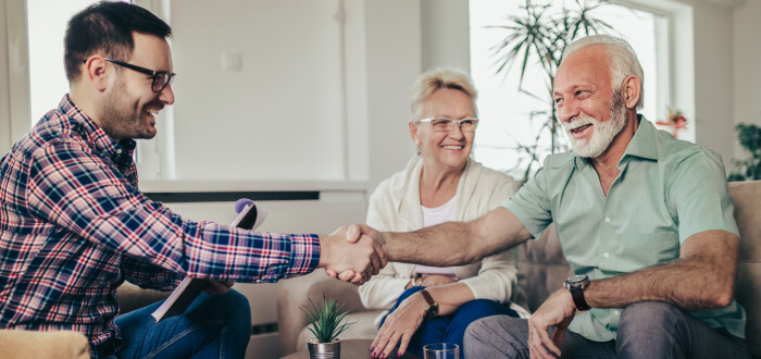 Older man shaking hands with man