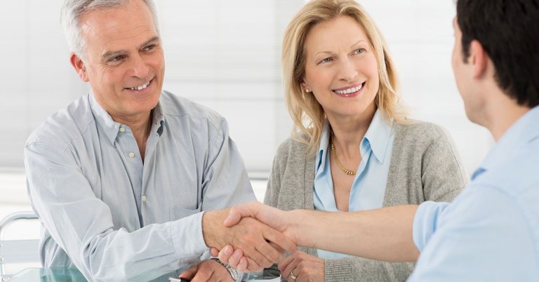 Elderly man and woman meeting with a lawyer