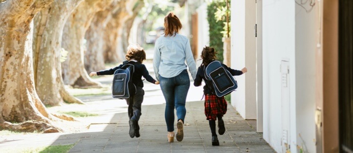 Mother walking two kids to school