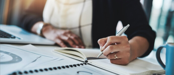 Professional taking notes at their desk