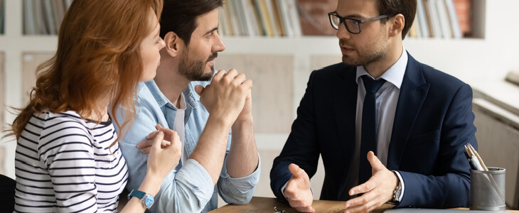 A couple consulting with a lawyer about the validity of a will