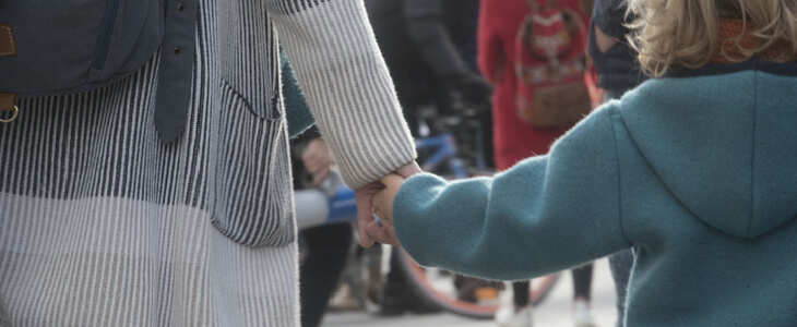 Young special needs girl holding hands with her guardian